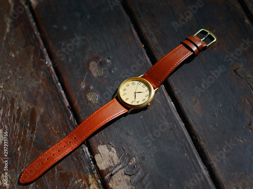 old wristwatch on brown background