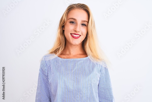 Young beautiful woman wearing elegant blue t-shirt standing over isolated white background with a happy and cool smile on face. Lucky person.