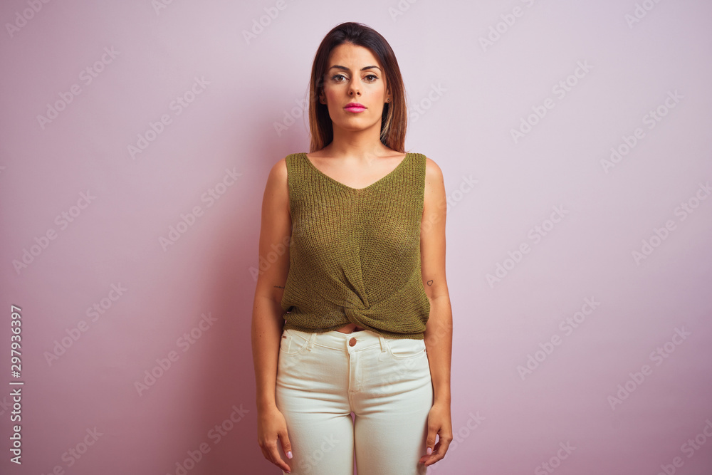Young beautiful hispanic woman standing wearing green t-shirt Young beautiful hispanic woman standing wearing green t-shirt