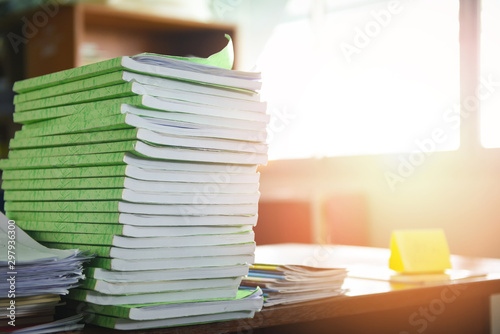 Lot of work document file working and book stacks of paper files searching information on work desk office - business report papers piles unfinished on the table