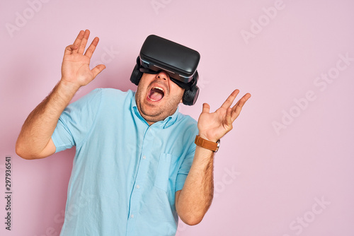 Young plus size man playing virtual reality game using goggles