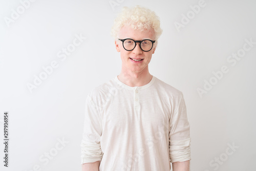 Young albino blond man wearing t-shirt and glasses standing over isolated white background with a happy and cool smile on face. Lucky person.