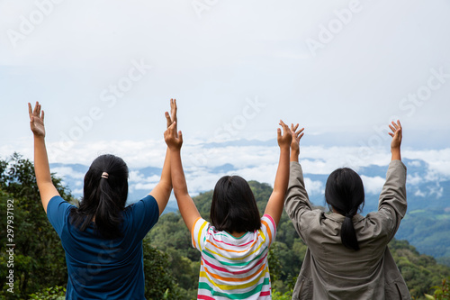 Happy teens deep breath fresh air on top mountain breathing clean air