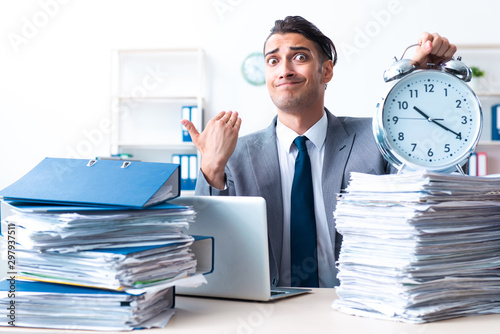 Businessman with heavy paperwork workload