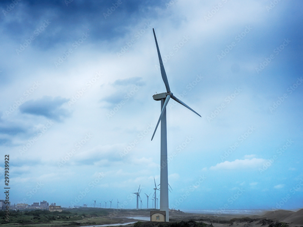 Beautiful dune and windmill in the beach dunes hill at Guanyin, Taiwan Beautiful dune and windmill in the beach dunes hill at Guanyin, Taiwan