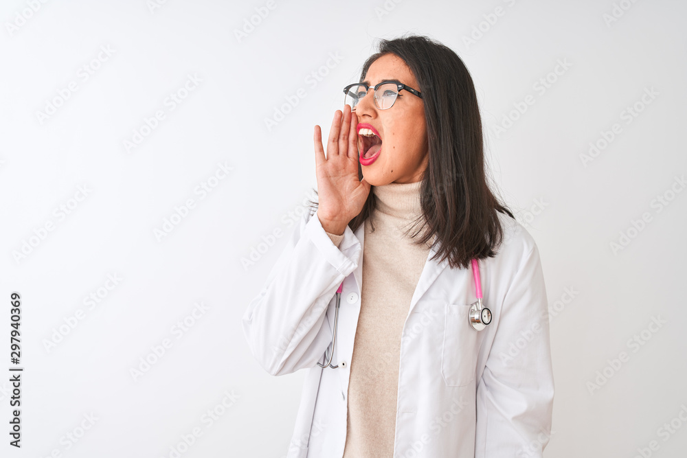 Chinese doctor woman wearing coat and pink stethoscope over isolated white background shouting and screaming loud to side with hand on mouth. Communication concept. Chinese doctor woman wearing coat and pink stethoscope over isolated white background shouting and screaming loud to side with hand on mouth. Communication concept.