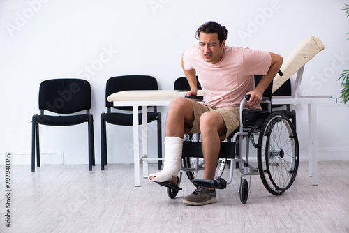 Young injured man waiting for his turn in hospital hall