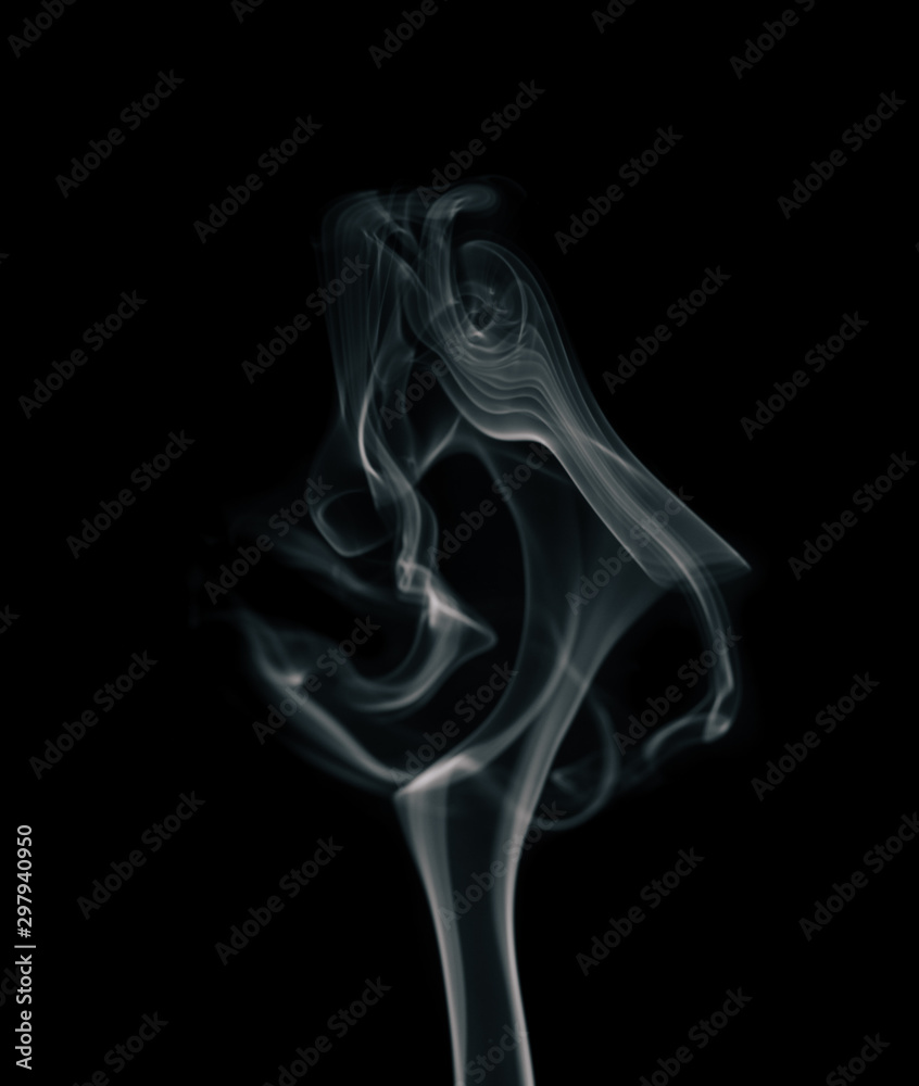 Movement of white smoke isolated on black background.Abstract shape and curve of smoke. Movement of white smoke isolated on black background.Abstract shape and curve of smoke.