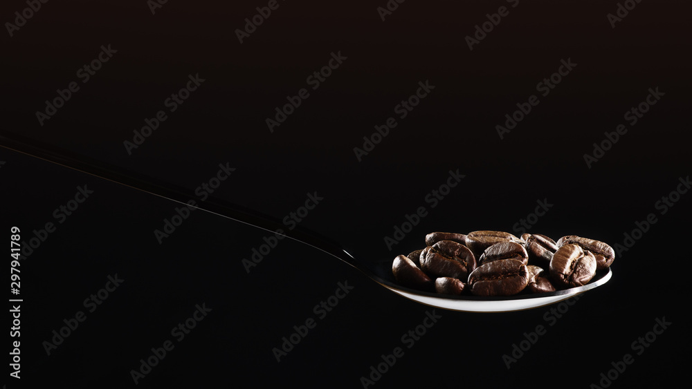 beverage background of roasted coffee beans in spoon isolated on dark background beverage background of roasted coffee beans in spoon isolated on dark background