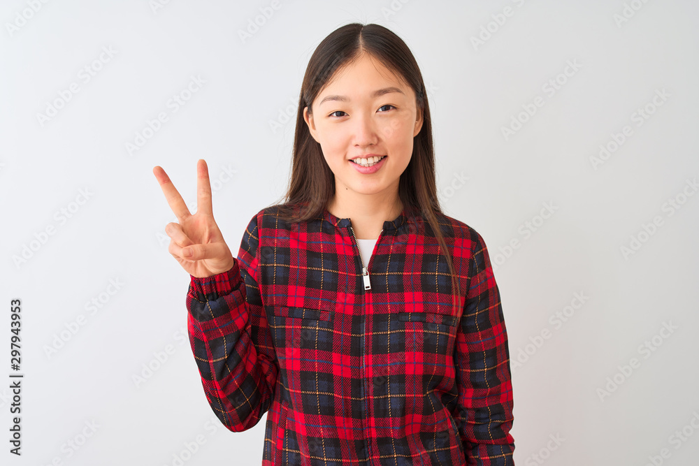 Young chinese woman wearing casual jacket standing over isolated white background showing and pointing up with fingers number two while smiling confident and happy. Young chinese woman wearing casual jacket standing over isolated white background showing and pointing up with fingers number two while smiling confident and happy.