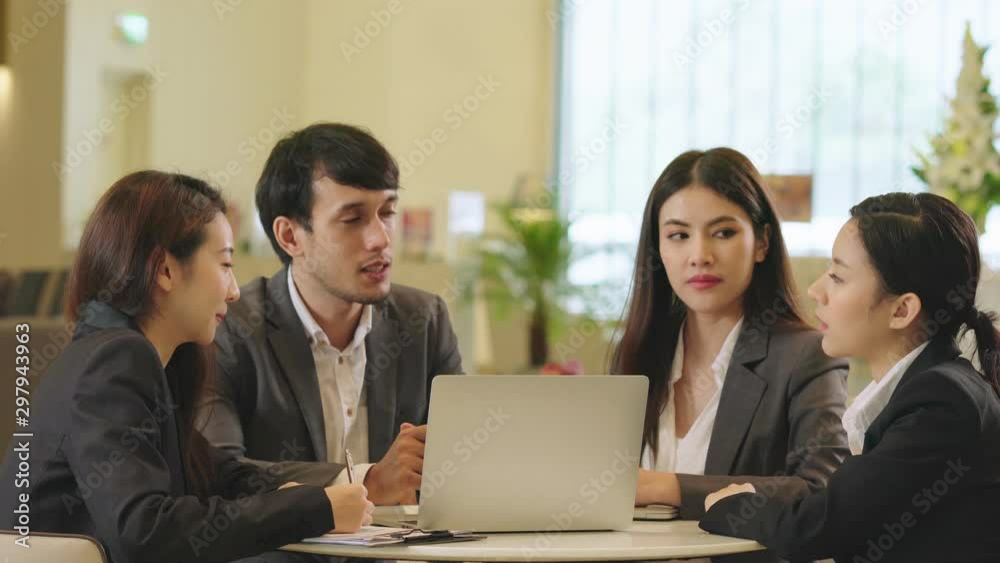 group of Businessmen and woman talking at meeting in modern design office with laptop and paper document group of Businessmen and woman talking at meeting in modern design office with laptop and paper document