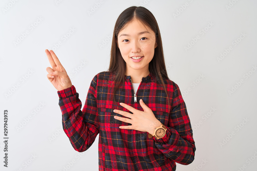 Young chinese woman wearing casual jacket standing over isolated white background smiling swearing with hand on chest and fingers up, making a loyalty promise oath Young chinese woman wearing casual jacket standing over isolated white background smiling swearing with hand on chest and fingers up, making a loyalty promise oath