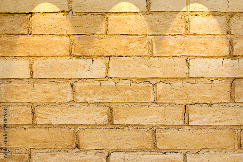 Adobe brick wall with spot lighting projection photo