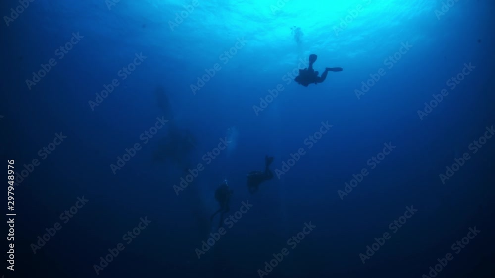 Wreck diving on shipwreck in underwater submarine world of ships from World War II as result of military battles on Truk Islands. Concept of diving in historic underwater sites of sunken wreck.