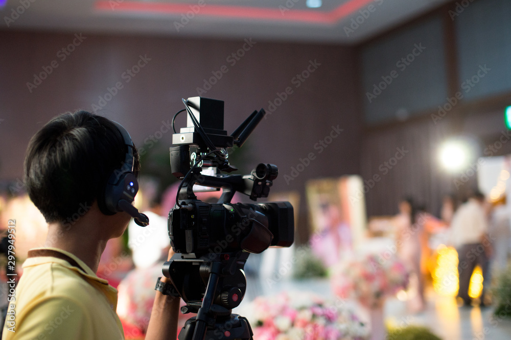 professional cameraman - covering on the event with a video