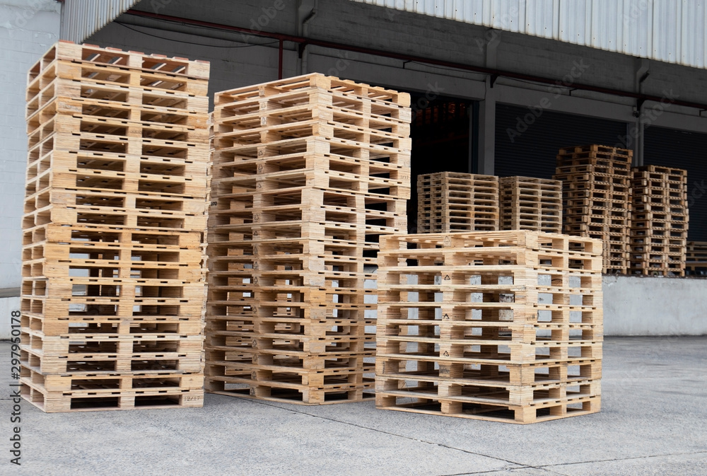 Stack of wooden pallets at storage warehouse. industrial logistics and cargo transport.