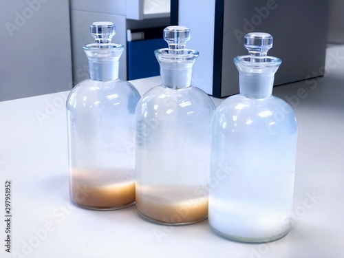 BOD bottle for analysis Biochemical Oxygen Demand in waste water sample, precipitation with solvent in flask, can use as a science background. Selective focus, blur background blue laboratory.