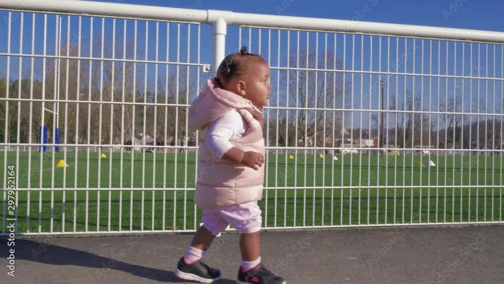 Baby girl first steps at the park, slow motion Baby girl first steps at the park, slow motion