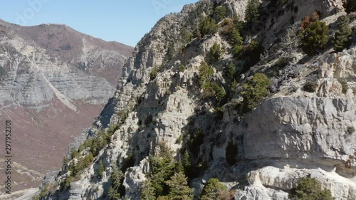 Aerial shot around steep rocky mountain and fall colors 