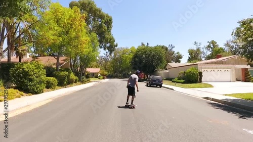 Wallpaper Mural Skateboarder carving a small hill in a neighborhood Torontodigital.ca