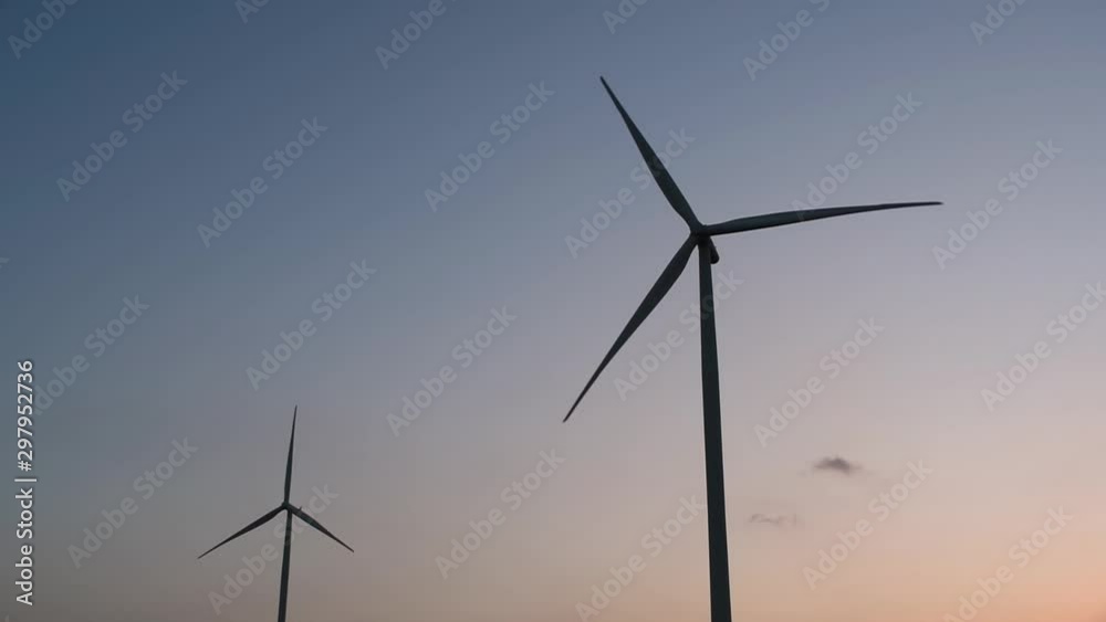 Wind Turbines Silhouette against the Blue-sky during Sunset, clean alternative energy in Thailand and mainland Southeast Asia. Wind Turbines Silhouette against the Blue-sky during Sunset, clean alternative energy in Thailand and mainland Southeast Asia.