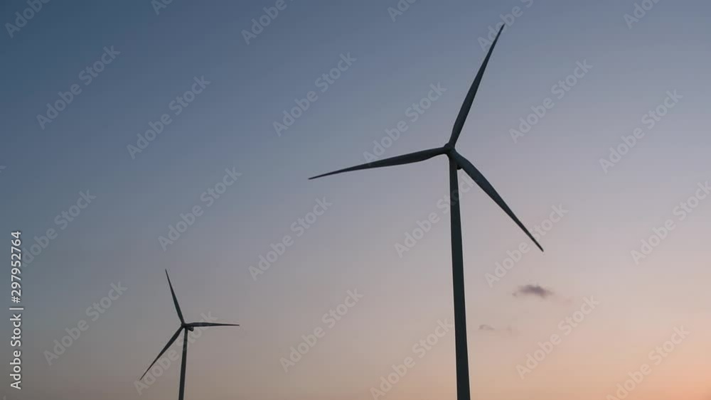 Wind Turbines Silhouette against the Blue-sky during Sunset, clean alternative energy in Thailand and mainland Southeast Asia. Wind Turbines Silhouette against the Blue-sky during Sunset, clean alternative energy in Thailand and mainland Southeast Asia.