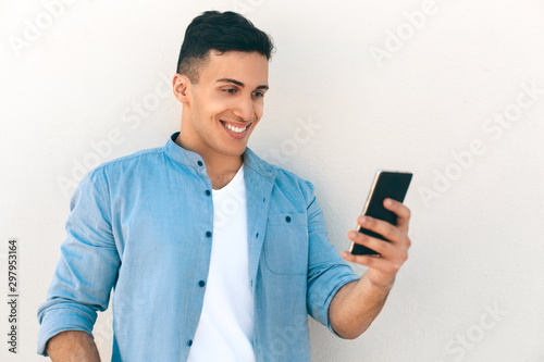 Outdoors Leisure. Stylish guy standing isolated on white having video call smiling cheerful