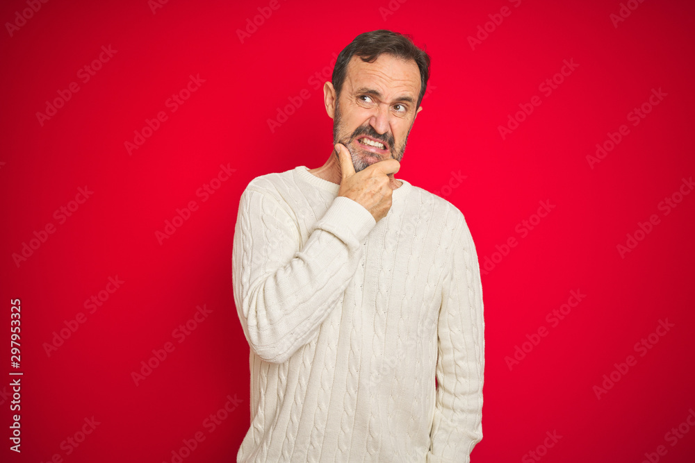 Handsome middle age senior man with grey hair over isolated red background Thinking worried about a question, concerned and nervous with hand on chin