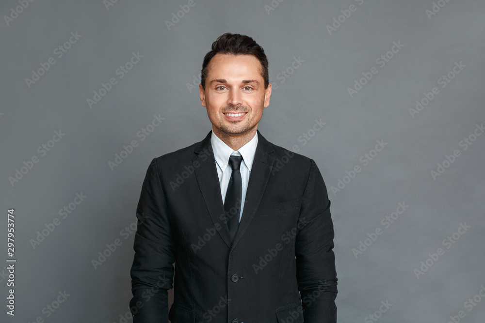Businessman studio standing isolated on grey looking camera cheerful Businessman studio standing isolated on grey looking camera cheerful