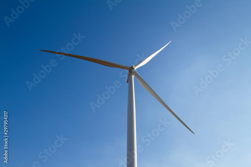Power of wind turbine generating electricity clean energy on blue sky