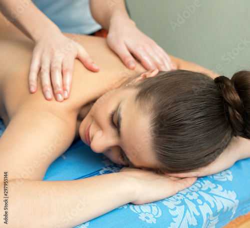 Young girl lying on her stomach having massage