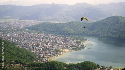 Paragliders flying against the Himalayas , Pokhara , Nepal.