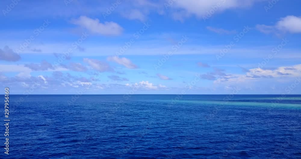 background shot of open ocean Great Barrier Reef Coral Pacific Ocean Queensland Australia, bright blue sky with fluffy clouds background shot of open ocean Great Barrier Reef Coral Pacific Ocean Queensland Australia, bright blue sky with fluffy clouds