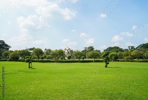 Nakornpathom / Thailand - May 09 2019: wide green yard with Ganesha shrine in sunny day at Sanam Chandra palace