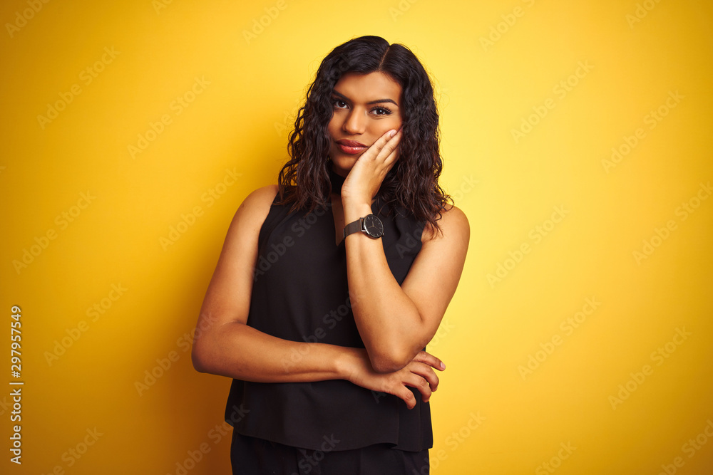 Fototapeta premium Transsexual transgender elegant businesswoman standing over isolated yellow background thinking looking tired and bored with depression problems with crossed arms.