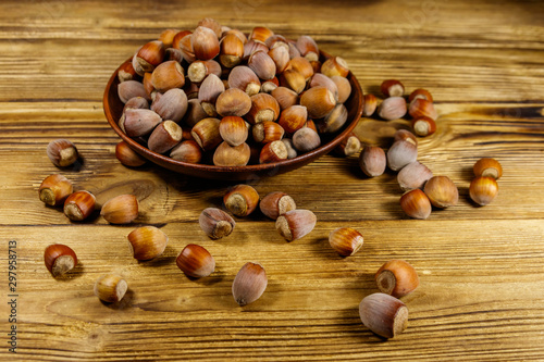 Hazelnuts in ceramic plate on a wooden table
