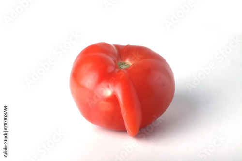 Concept of ugly food - ugly tomato on white background