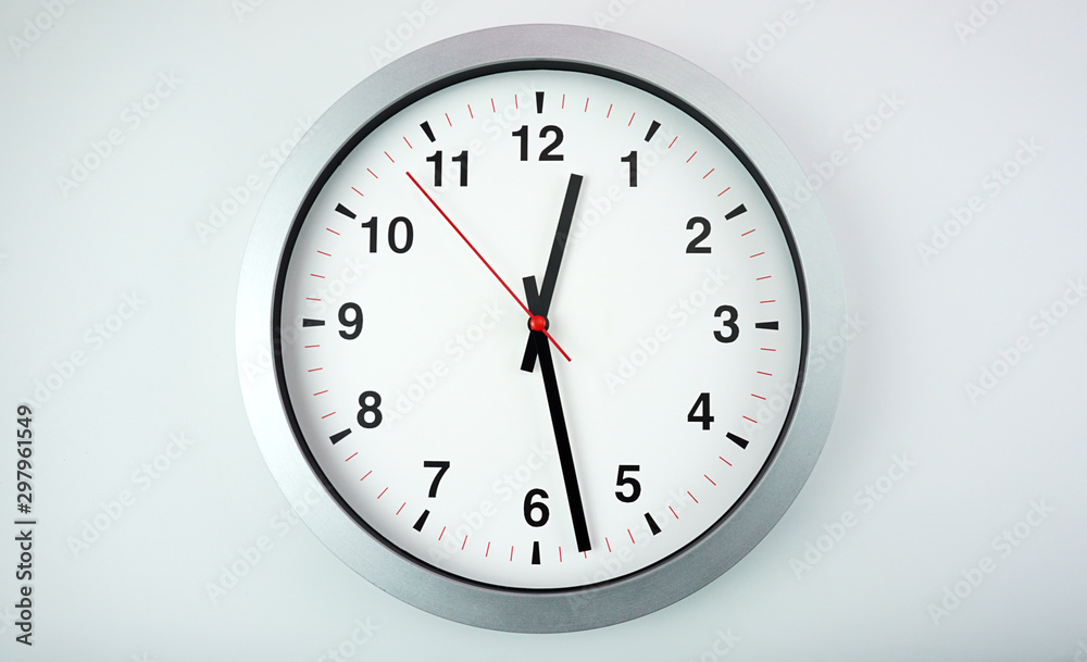 Gray wall clock face beginning of time 12.28 am or pm on White background, Copy space for your text, Time concept.. Gray wall clock face beginning of time 12.28 am or pm on White background, Copy space for your text, Time concept..