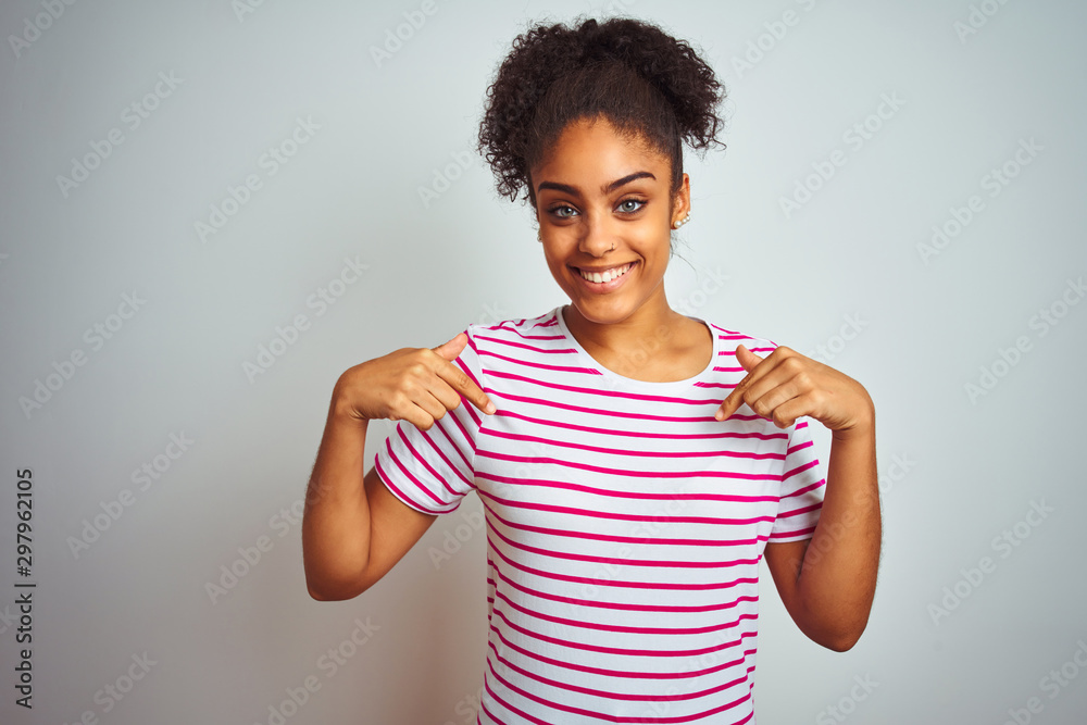 African american woman wearing casual pink striped t-shirt over isolated white background looking confident with smile on face, pointing oneself with fingers proud and happy. African american woman wearing casual pink striped t-shirt over isolated white background looking confident with smile on face, pointing oneself with fingers proud and happy.