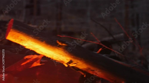 Wallpaper Mural A light from the bonfire reflecting on the wood in the forest - an iron wire on the background Torontodigital.ca
