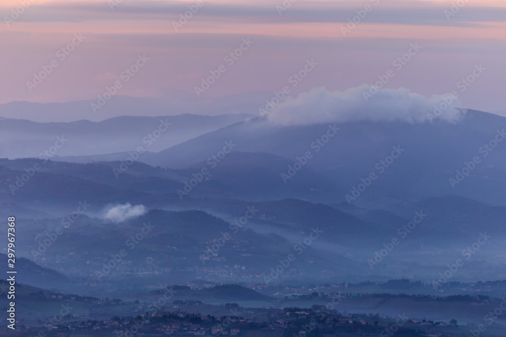 A view of Umbria valley with hills and mist