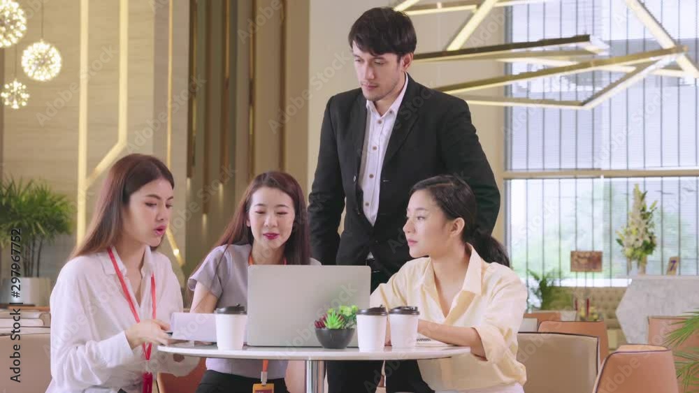 group of Businessmen and woman talking at meeting in modern design office with laptop and paper document group of Businessmen and woman talking at meeting in modern design office with laptop and paper document