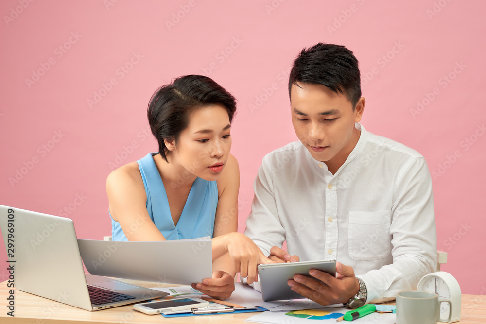 Smiling business people using a computer in their office Smiling business people using a computer in their office