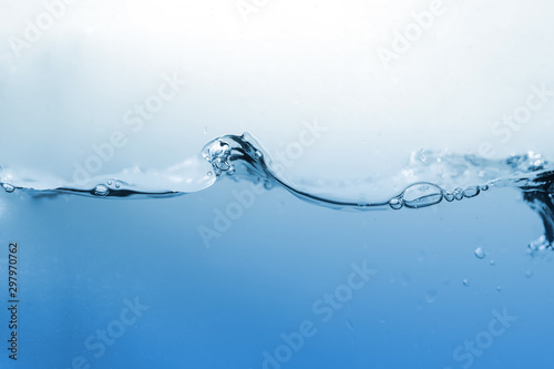 Water splash or water wave with bubbles of air on the background.