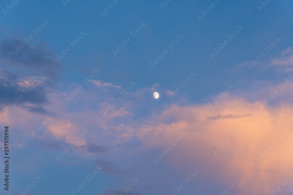 Incomplete moon in the sky during sunset at dusk. Incomplete moon in the sky during sunset at dusk.