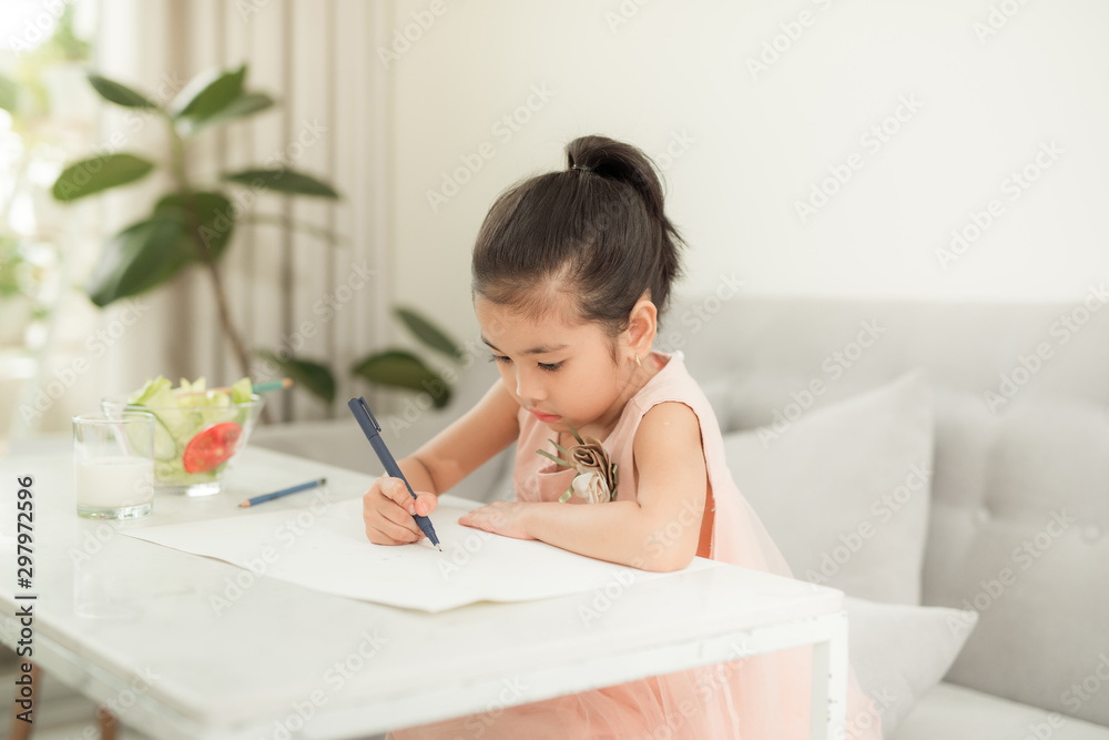 Little girl drawing picture at table with painting tools indoors Little girl drawing picture at table with painting tools indoors