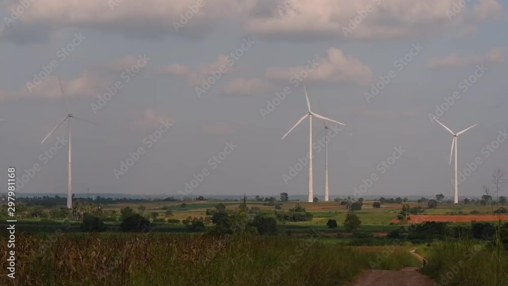 Wind Turbines Towering Farmlands, as farmers grow their crops and tend their animals; clean alternative energy in Thailand and mainland Southeast Asia. Wind Turbines Towering Farmlands, as farmers grow their crops and tend their animals; clean alternative energy in Thailand and mainland Southeast Asia.