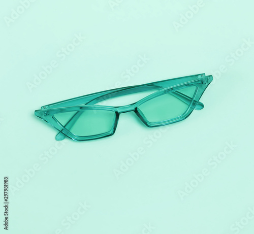 Stylish sunglasses isolated on the pastel green or mint background. photo