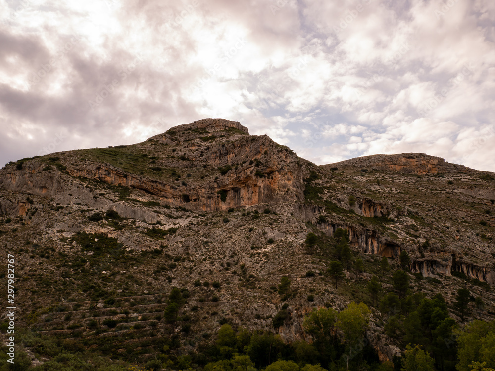 mountainous peak with caves and hiking trail