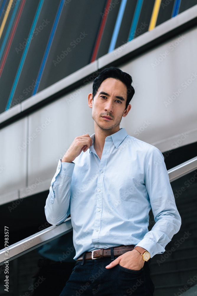 Portrait of young successful businessman in suit looking in front of camera Portrait of young successful businessman in suit looking in front of camera